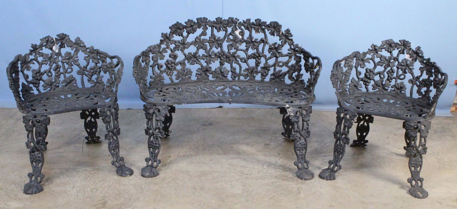 20th C. Cast Iron 3 Piece Garden Set w/ Grapes: 20th C. Cast Iron 3 Piece Garden Set with Grapes in Back and Seat. The set includes (1) Bench 28 1/2" High X 38 1/4" Wide X 21 1/4" Deep. (2) Chairs 26 1/4" high X 22" Wide. Condition - Good condition