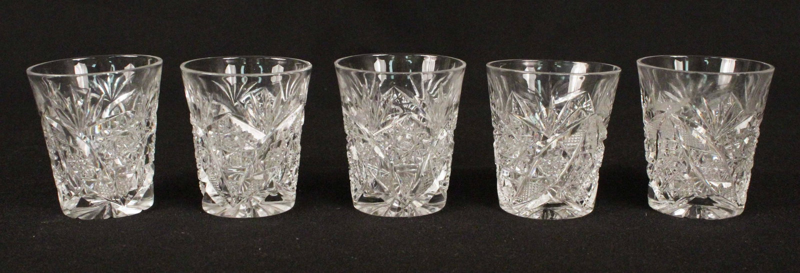 Five American Brilliant Cut Glass Shot Glasses: Five American Brilliant Cut Glass Shot Glasses. Measure 2 3/8" High. Condition - (4) Are in good condition, no chips or cracks. (1) Has two very small nicks on the bottom.
