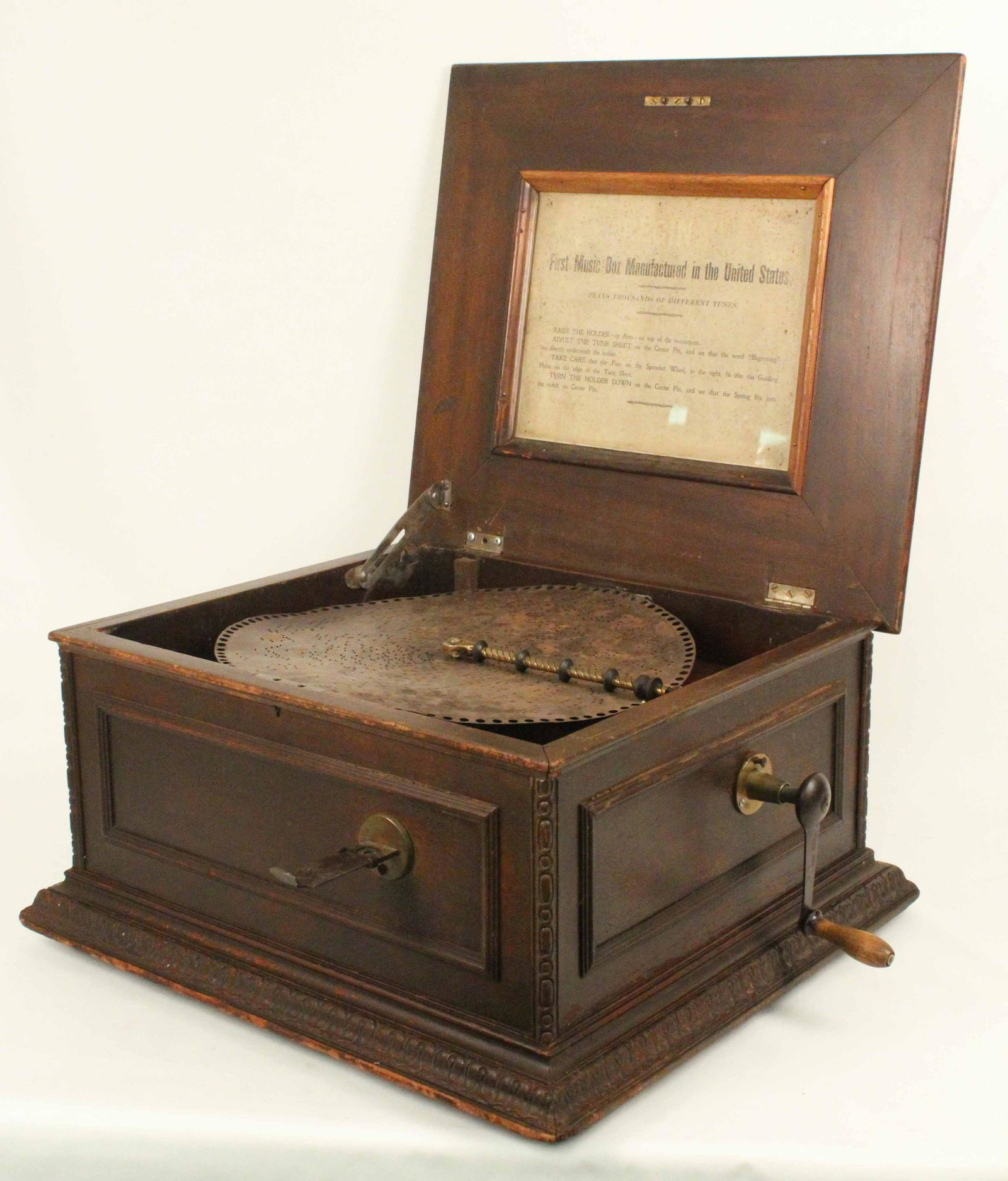 Regina Coin-Operated 15.5" Music Box: Regina Coin-Operated 15.5" Music Box. A footed 1890s table-top carved mahogany Regina music box. This twin combed coin operated player is very scarce. Serial Number: 53460. Measures 13" high X 22 1/2"
