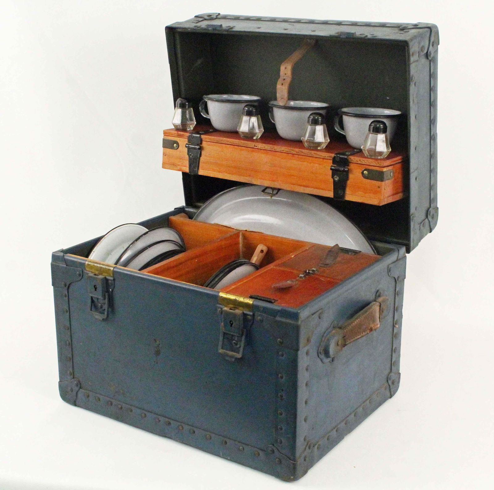 WWII Herkert & Meisel Mess Trunk, 1944: WWII Herkert & Meisel Trunk Mess Trunk, 1944. (9) 9 1/2" granite ware plates. (8) 9" granite ware bowls. (1) Granite ware platter, approx. 12" X 15 1/2". Includes some period flatware. (4) Salt and pe