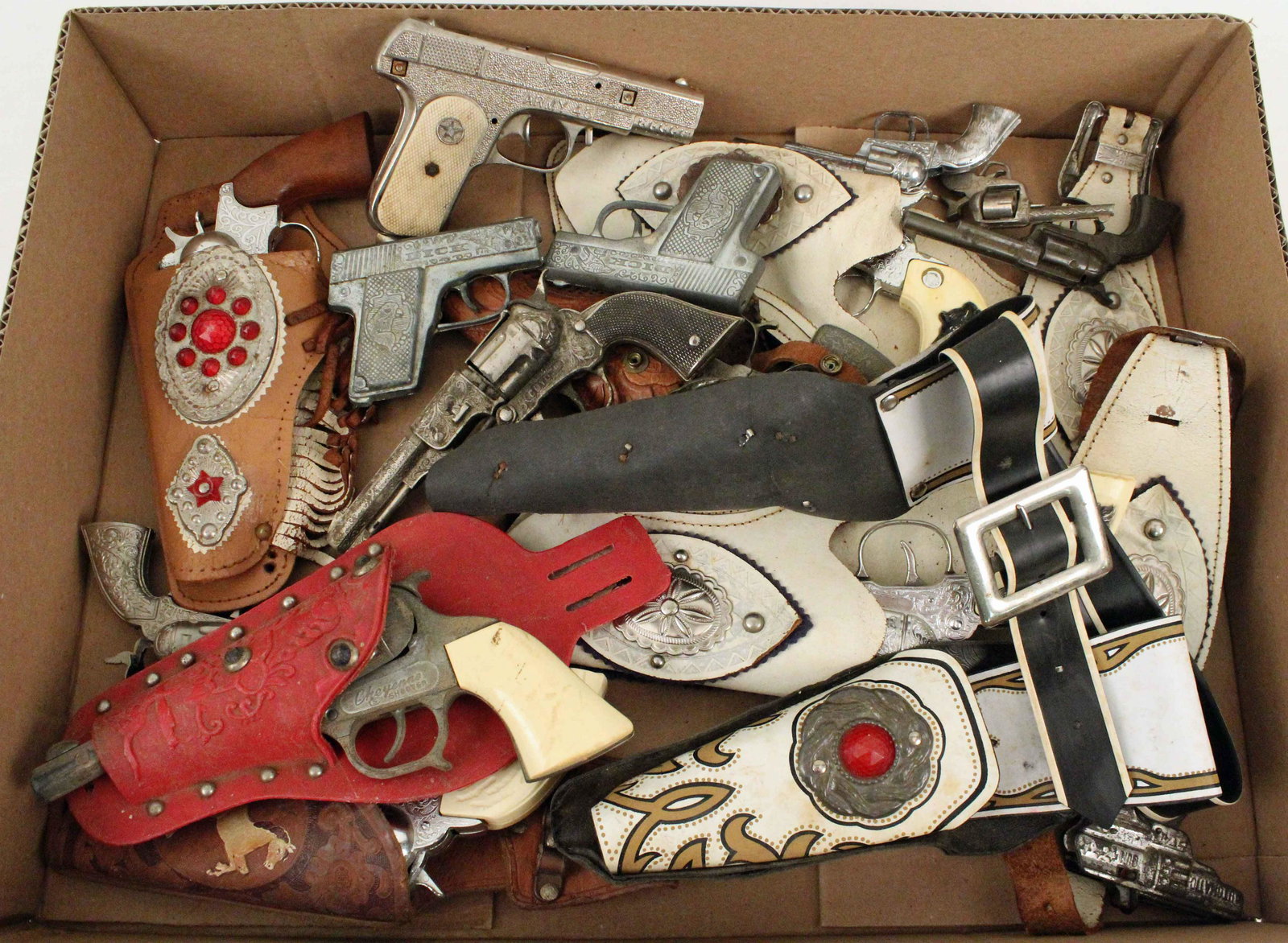 Group of 14 Cap Gun Pistols and Holsters: Group of 14 Cap Gun Pistols and Holsters. (1) Red Kilgore jeweled molded plastic holster. (1) Hubley Texan Army 45 pistol. (1) Crescent Toys Super Cowboy pistol. (1) Roy Rogers with leather holster. (