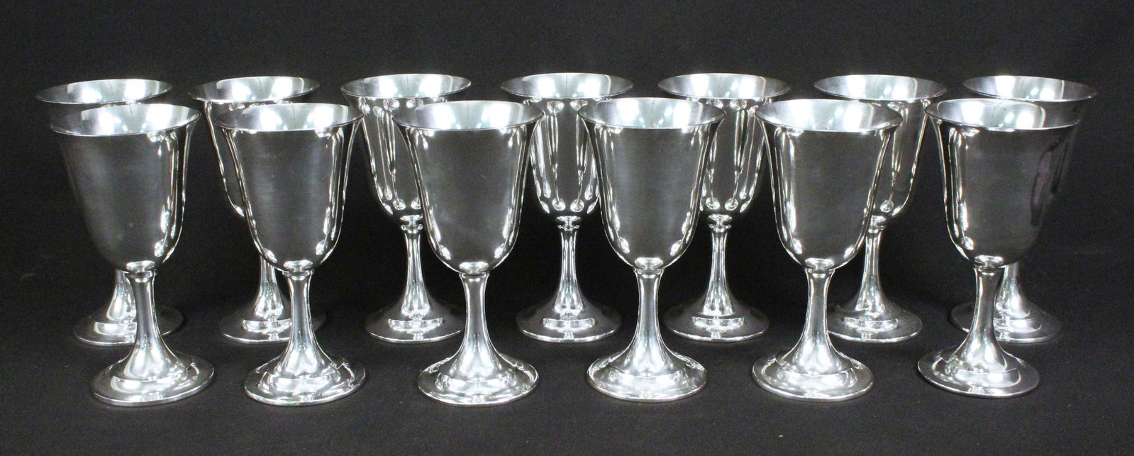 13 International Sterling "P664" Wine Goblets: 13 International Sterling "P664" Wine Goblets. Total weight: 69 Ounces Troy. Sterling silver goblets measure 6 1/2" high X 3 3/8" dia. at top. Provenance: Lynne Fairchild Spragins Dodson estate, Jacks