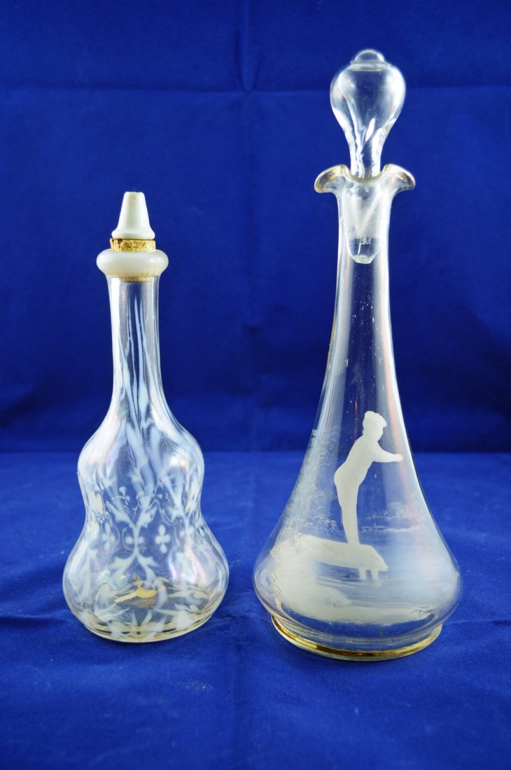 Mary Gregory Decanter & Spanish Lace- Bottle: Mary Gregory decanter with lad standing on a lake pier; opalescent Spanish lace Barber's bottle. Decanter is 11" tall and Barber's bottle is 7.5" tall.