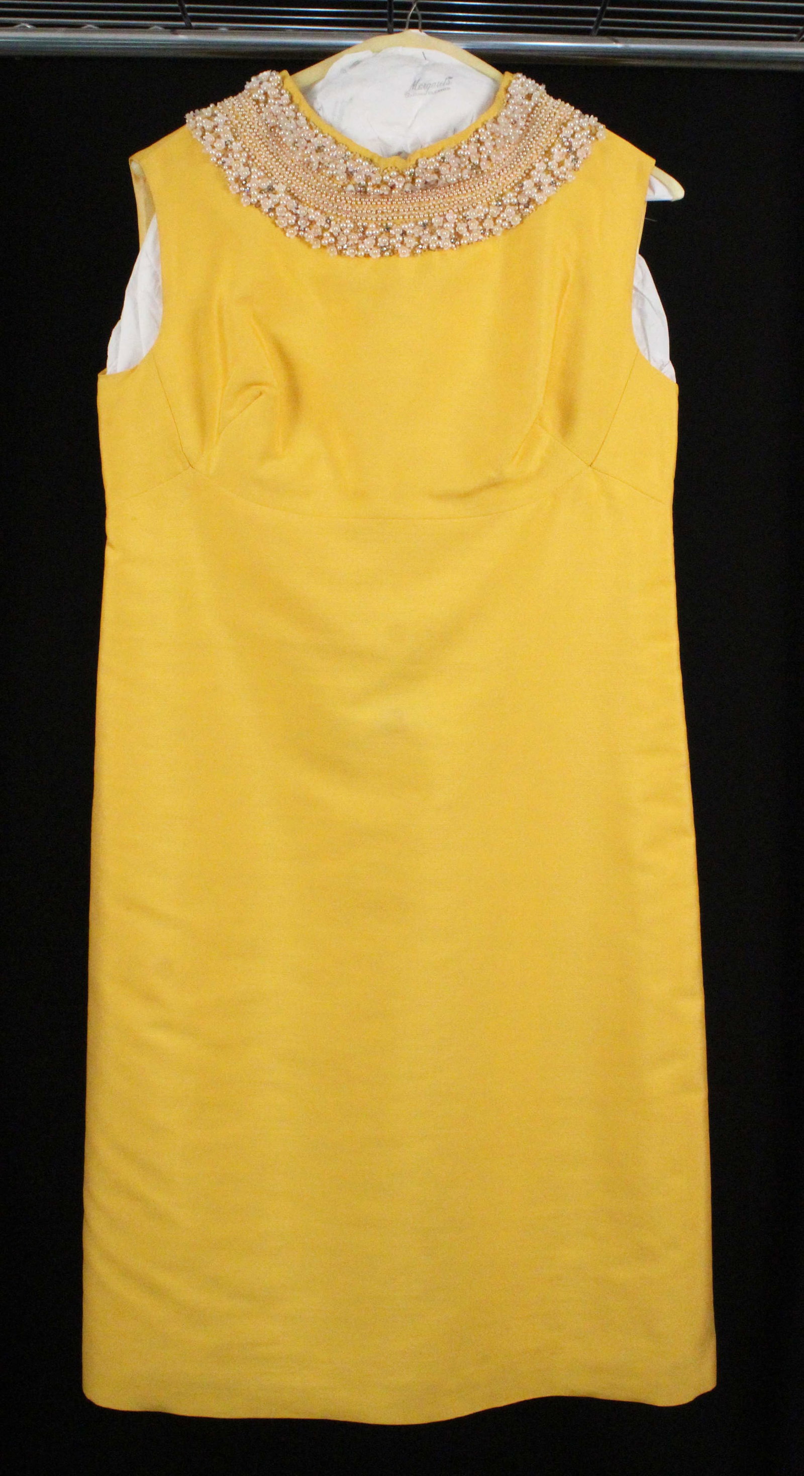 Muriel Martin Canary Yellow Silk Cocktail Dress: Muriel Martin Canary Yellow Silk Cocktail Dress. Cocktail dress with straight skirt cut, empire waisted, and heavily encrusted collar with pearls, crystal, floral beads, and small beads. Labeled, "Mur