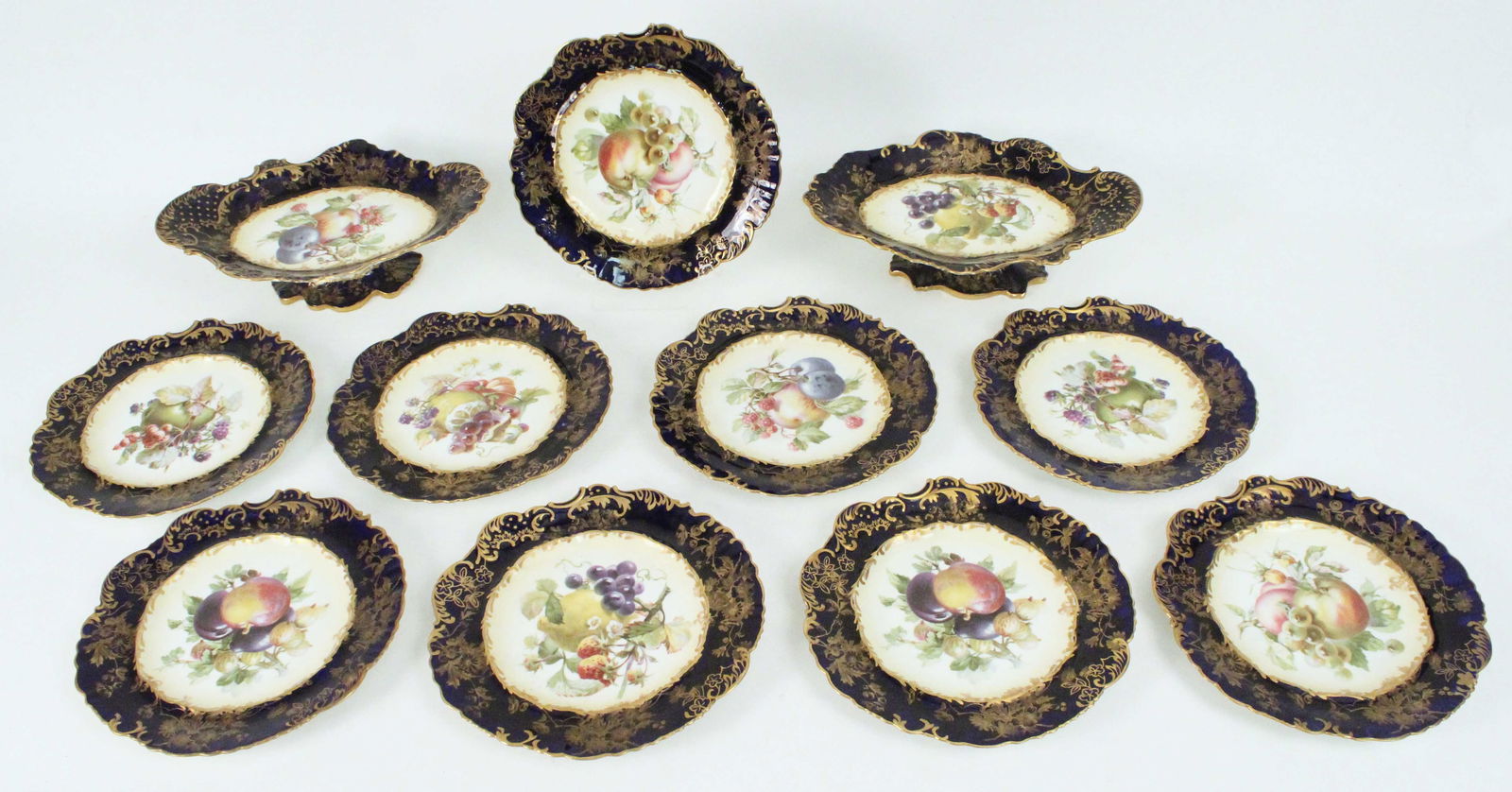 Hammersley Pattern #4935 China, (11) Pcs.: Hammersley Pattern #4935 English Bone China, (11) Pieces. Fine china with cobalt gold trim rims and fruit and flower decorations. (9) Luncheon or dessert plates, 8 5/8" diameter. (2) Compotes, 3 1/4"