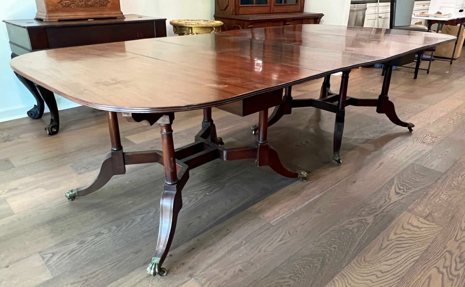 Four Part Federal Mahogany Dinning Table: Four Part Federal Mahogany Dinning Table with Brass Claw Feet Caps. Measures 30" high X 110" long X 50 3/4" wide. Condition- Overall good condition with some wear and scratches. One end "D" leaf is no