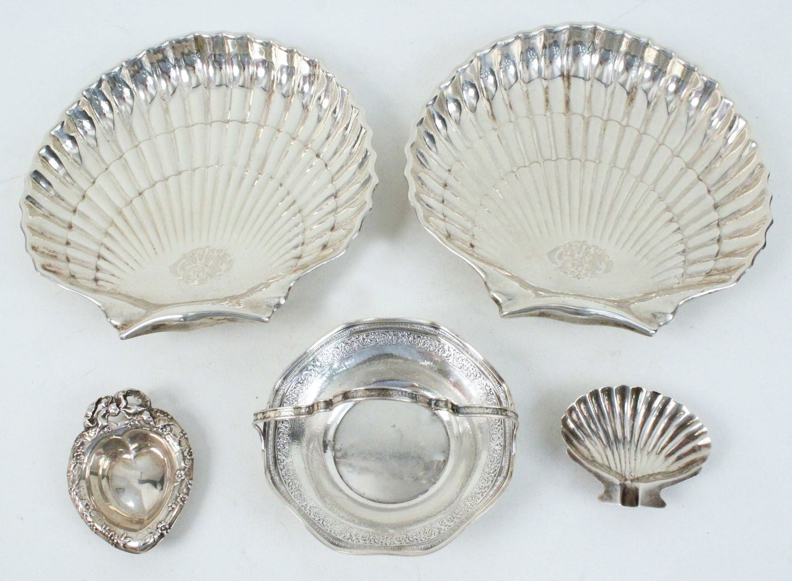 Sterling Silver Shell Serving Trays, Etc.: Sterling Silver Shell Serving Trays, Etc. (2) Gorham shell design serving dishes #40617. Measure approximately 9 1/8" X 9 1/8". (1) Webster mint dish with handle, 3 3/4" high X 5 3/8" wide. Both shell
