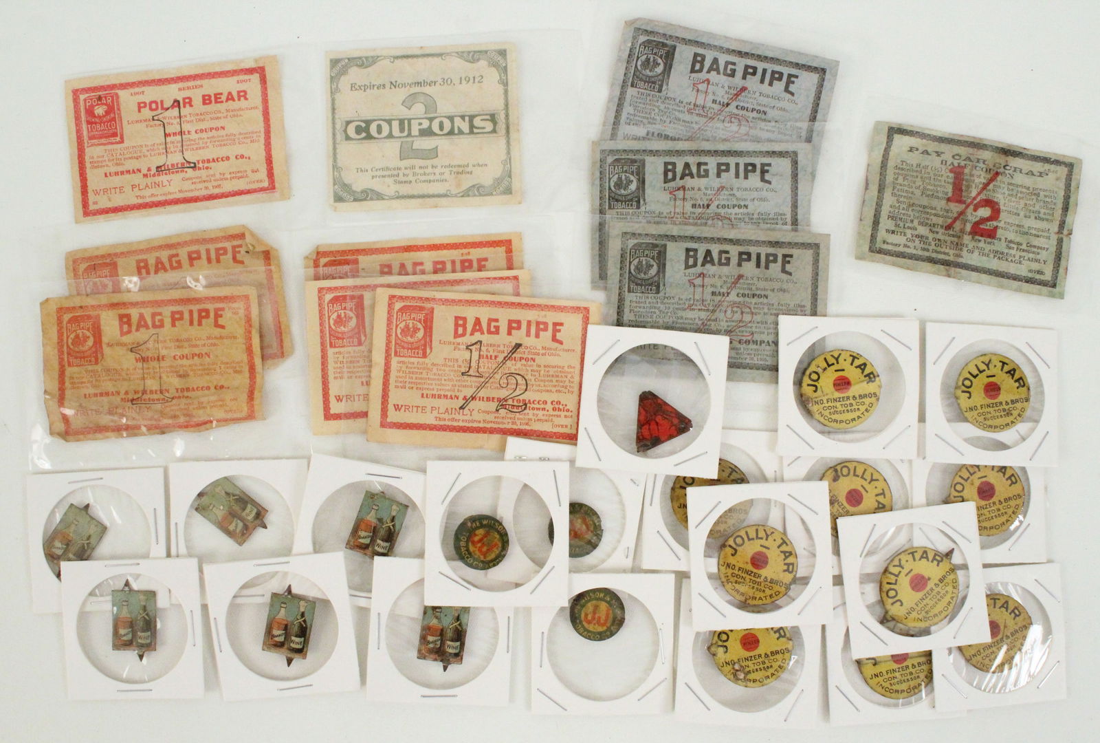 (20) Tin Tobacco Tags & (11) Tobacco Coupons: (20) Antique tin tobacco tags. Includes: (10) Jolly Tar; (6) Brandy Wine; (3) The Wilson & McCallay Tobacco Co. (1) Stag. (11) Tobacco paper coupons. Provenance the remaining inventory of Antique Arch