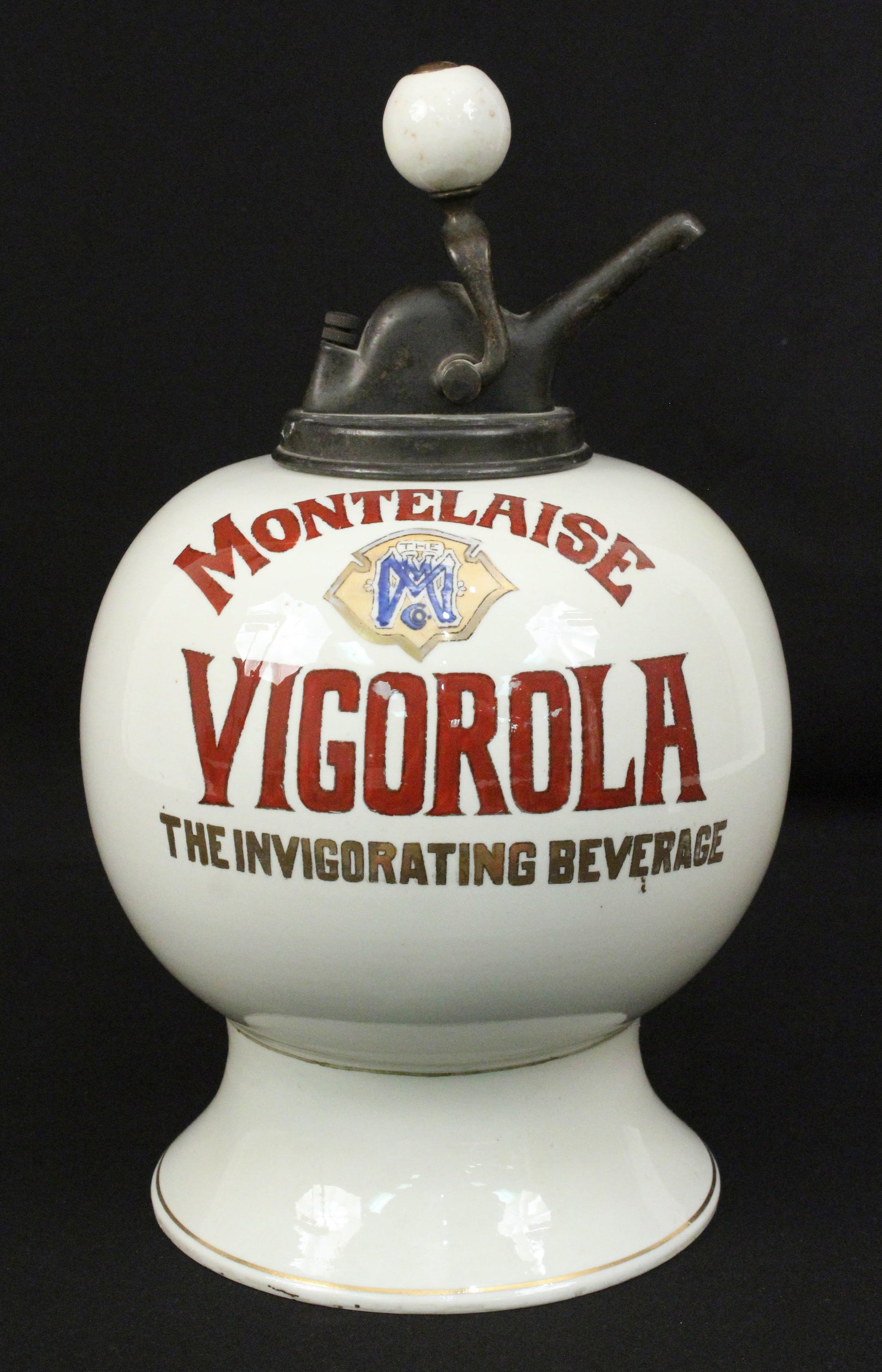 Montelaise Vigorola Syrup Dispenser: Montelaise Vigorola Soda Fountain White Porcelain Syrup Dispenser. Beautiful dispenser with crimson and gold leaf lettering and gold leaf pin stripe. Nice pump with porcelain ball. Displays very well.