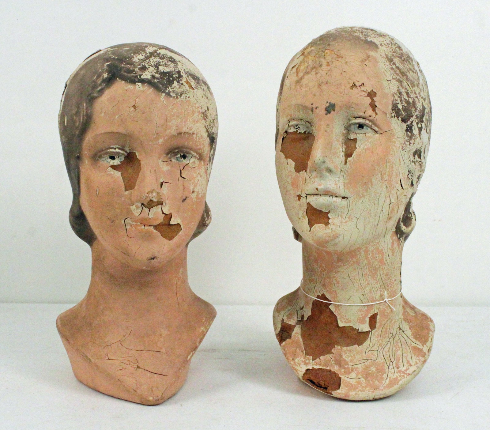 (2) 1920's Mannequin Composition Heads: (2) 1920's Mannequin Composition Heads. Measure approximately 14 1/2" high X 6 1/2" diameter and 13 1/2" high X 6 1/2" diameter. Provenance the remaining inventory of Antique Archaeology, closed Nashv