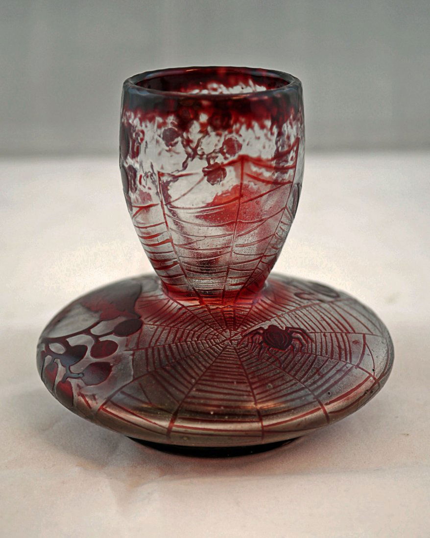 Daum Nancy Ruby Cameo Glass Spider Vase: Signed Daum Nancy Cross of Lorraine, ruby cameo glass spider vase with spider web, sinister spider, grapes and grapevines, ruby cameo glass cut to clear. 3.5" H. X 3.5" dia..A very elusive piece of Da