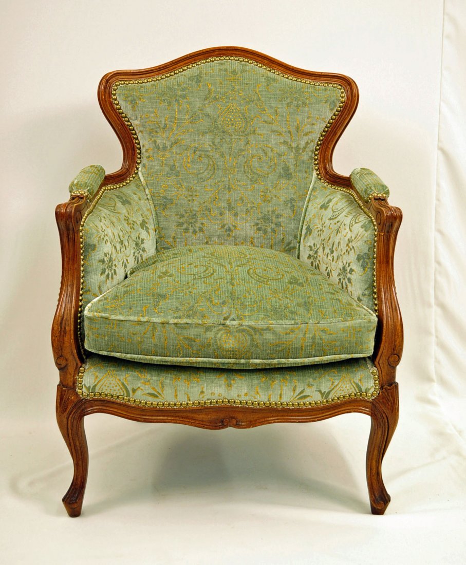 Louis XV Style Carved Walnut Bergere Arm Chair: Louis XV style carved walnut finish Bergere arm chair with shaped and upholstered back and seat. Measures - 35" H. X 25.5" W. X 24.5" D.