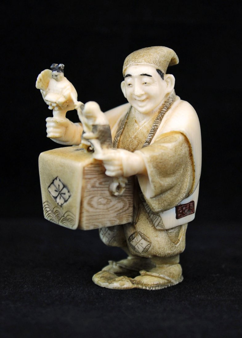 Ivory Netsuke of a Puppeteer, Nineteenth Century: Carved ivory netsuke of a puppeteer, nineteenth century, signed. Measures 2.25" H.