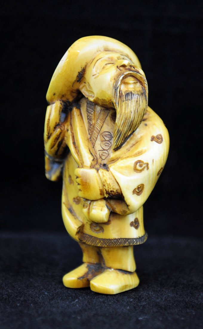 Carved Ivory Netsuke Man In Hat 19th Century: Carved ivory Netsuke "Man In Hat" 19th Century. Signed on base. Measures - 2.10" H.