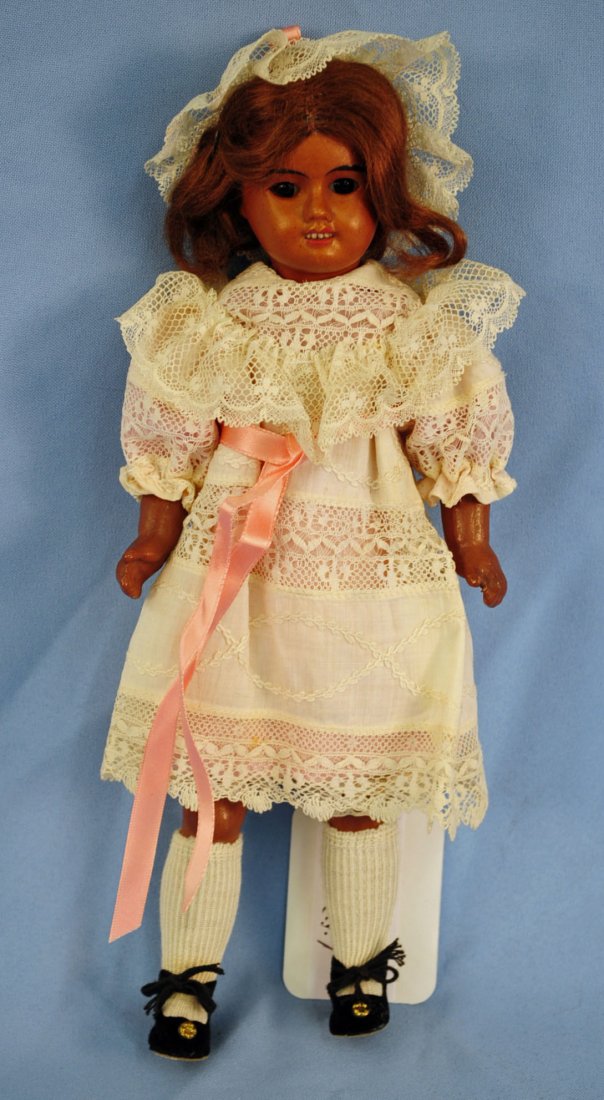 French 10.5" Bisque Socket Head Unis Doll: French 10.5" Bisque Socket Head Unis Doll. Incised, "60, Unis, France." Doll has open mouth with teeth, set eyes, ball joint composition body, and a white antique crochet lace dress with matching hat.