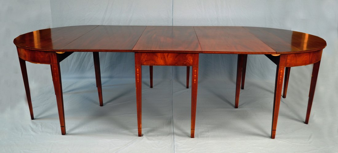 Mid 20th C. Hepplewhite Mahogany Dining Table: Mid 20th Century Inlaid Hepplewhite Mahogany Dining Table each end has a D-form with hinged drop leaf, the center section rectangular and with twin hinged leaves, skirted with crotch mahogany and band