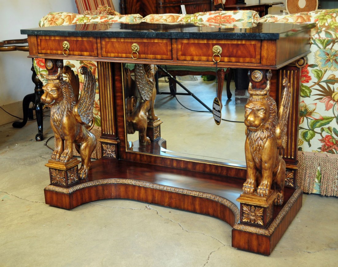 Maitland-Smith Pier Table with Winged Gilded Griffins: Maitland-Smith Pier Table with Winged Gilded Griffins and Banded Crotch Mahogany Veneer, Top is Polished Black Waxstone Veneer. Base of table has beveled mirror. Height: 32 1/2 in. by Width: 44 1/2 in