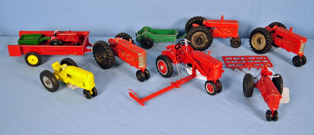 10 Piece Lot of Toy Tractors and Implements: 10 Piece Lot of Toy Tractors and Implements Includes plastic model Red B Tractor with mower - includes decal and instruction for application, cast metal unmarked toy tractor and trailer, 3 Lee Toys Tr