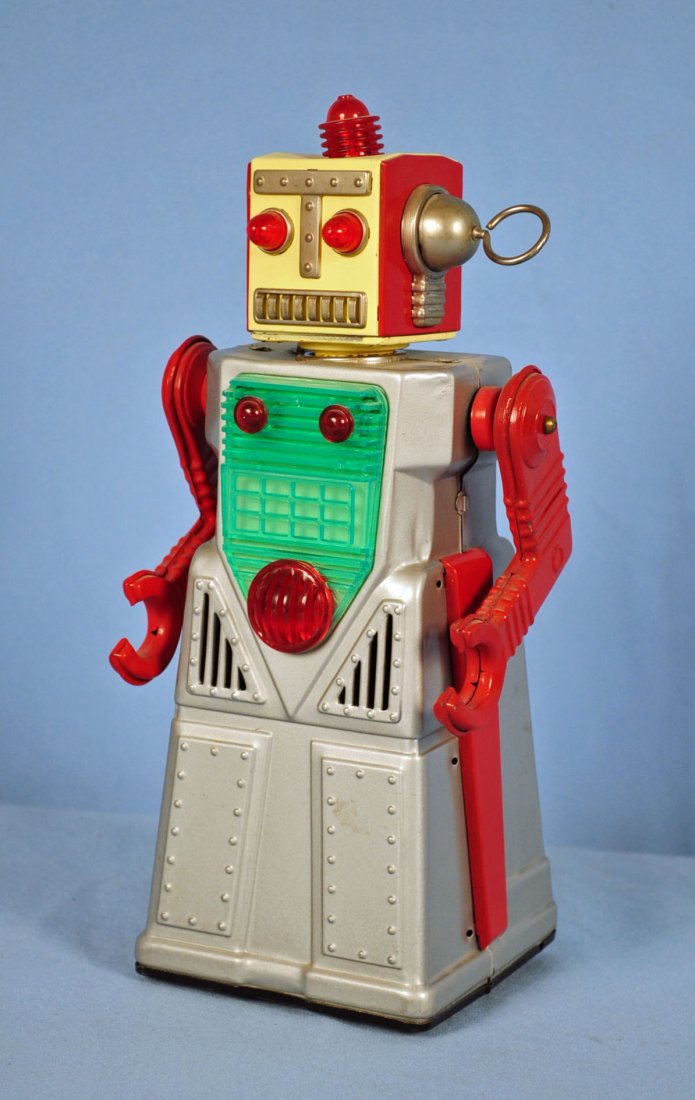 Battery Operated Chief Robotman Tin Toy by KO: Battery Operated Chief Robotman Tin Toy by KO Circa 1950's tin robot with plastic chest plate. 12" tall. Marked "Japan KO" on bottom. Condition - not working. Missing one piece from side of head. Has
