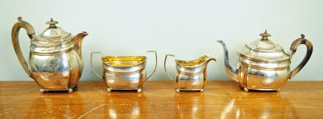 Peter & Wm. Bateman Sterling Silver Tea Set, 1807: Four piece George III Peter & William Bateman, 1807, sterling footed tea service with rosewood handles. Total Overall Weight Approx. 50 Troy oz. Sterling. Measurements: Coffee pot 8 3/8" to top of han