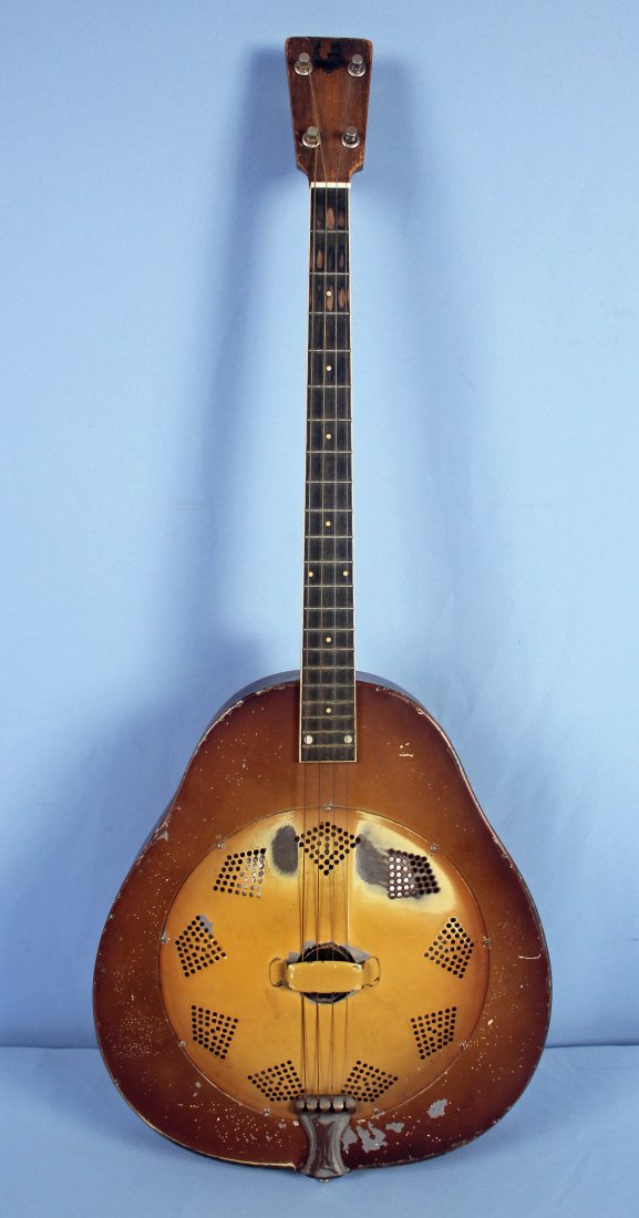 C 1930 National Triolian Resonator Guitar: An early 1930s National Triolian resonator guitar. The guitar is finished in polychrome on a pear-shaped body. Overall length of approx. 35" and a 14.25" x 15.5" body. - Condition: Body has wear and p