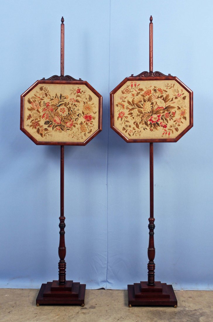 Pair English Mahogany Fire Screens w/ Needlepoint: A 19th Century Pair of English Mahogany Fire Screens with Needlepoint Shields. 60" High with 15" X 17" shields. - Condition: Fire screens are in good condition.