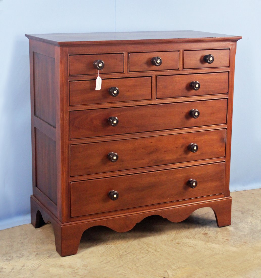 Henredon Mahogany Bracket Foot Chest of Drawers: Henredon mahogany bracket foot chest of drawers. Chest has eight drawers with ebonized pulls and simulated porcelain centers above scallop-skirted base. Chest has Henredon tag attached to back. One of