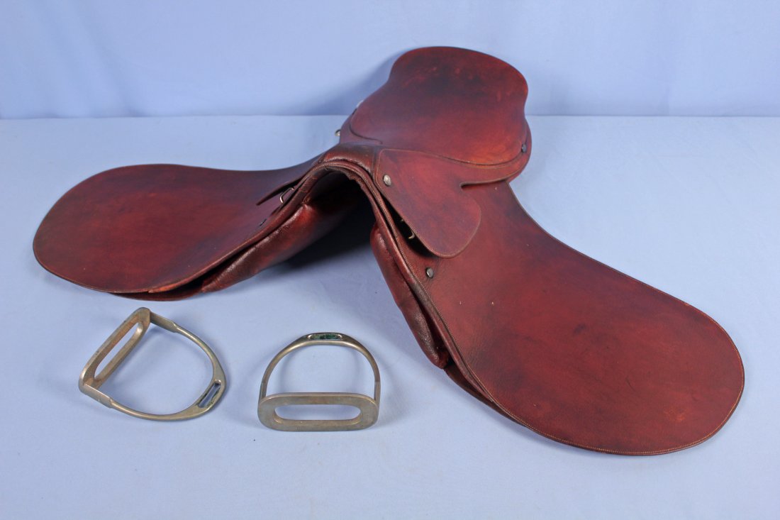 Early Champion & Wilton English Jumping Saddle: 1940s Champion & Wilton English jumping saddle with King George VI warrant. Saddle and stirrups are marked Champion and Wilton. Saddle has King George VI Warrent seal. Saddle measures 20.5" long. - Co