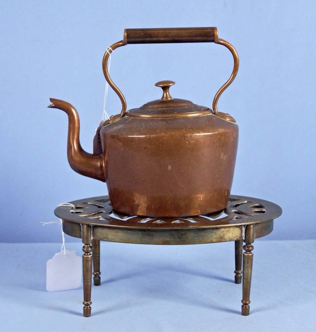 Dovetailed Copper Kettle & Handmade Brass Trivet: Dovetailed Copper Kettle & Handmade Brass Trivet. Fixed Handled Kettle is 8.5" H. and has a flower stamped on the base. The Oval Pierced Top Trivet measures- 7" X 10.5 and is 4.5" H. - Condition trive