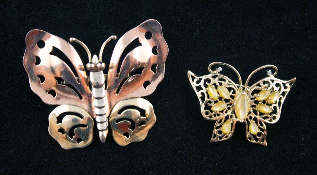 2 - 14kt Gold Butterfly Pins/Pendants: One 14kt Gold signed M. C. Mossolone tri-color butterfly pin with pierced decoration. Measures approx. 1.75" x 2". 17.4 grams total weight. .56 Troy oz.. One 14kt gold pierced design butterfly with tw