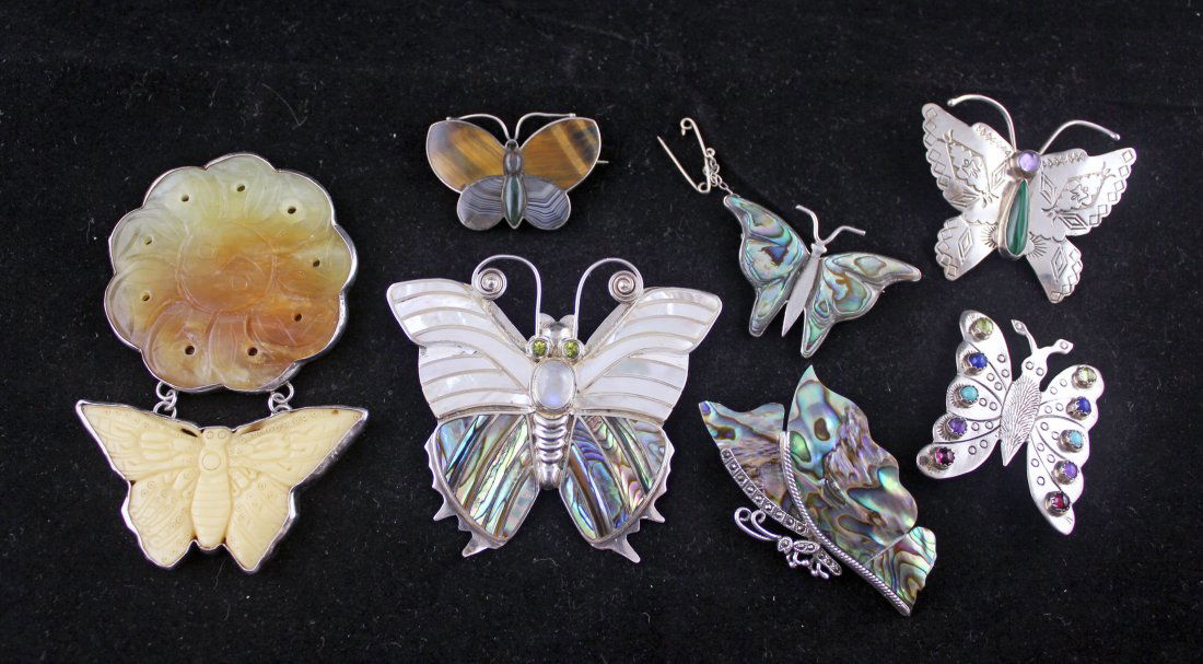 Grp of 7 Sterling Butterfly Pins/Brooches/Pendants: One sterling silver Sajen butterfly with abalone, peridot, and mother of pearl decorations, measures approx. 2.5" x 2.75". One signed "Joan Slifka" jade butterfly and flower brooch/pendant marked .925