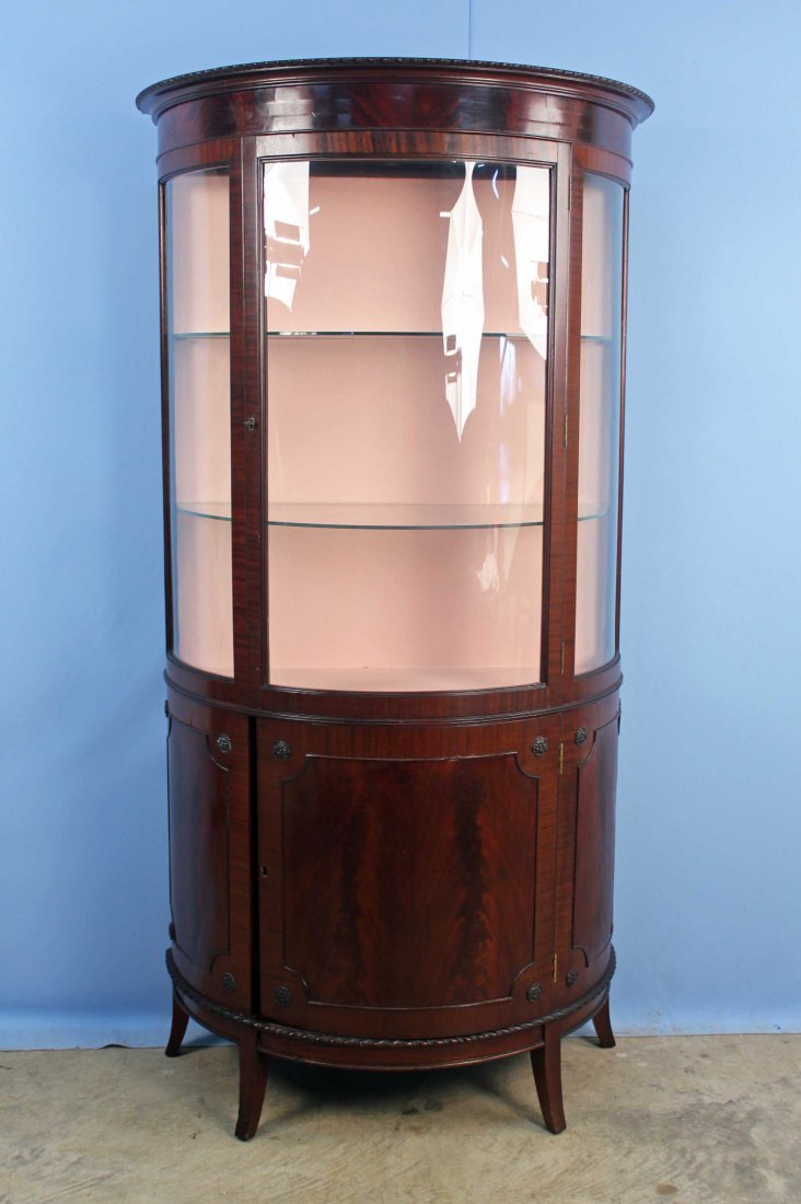 Edwardian Style Demilune Mahogany China Cabinet: Edwardian Style Demilune Mahogany China Cabinet . Flamed mahogany panels and top band. Curved glass end panels and plexiglass center door. Measures 68.25" High X 35.5" Wide X 18" Deep. Condition - Bot