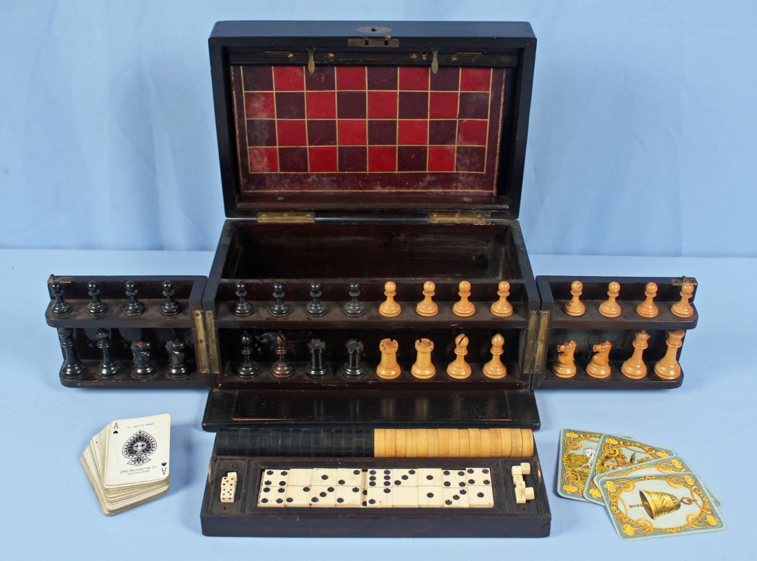 19th C. Chess, Checkers, & Dominos Game Set: 19th Century cased chess, checkers, and dominos game set. Lockable case with hinged front and to. Original leather chess, checker, and backgammon board. Set also includes turned wooden checkers, chess