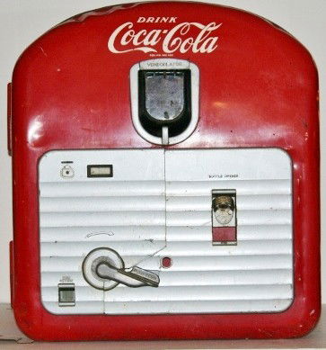 Counter Top Coca Cola Machine: Vendorlator 27 countertop Coca Cola dispenser. This is the smallest machine that Vendorlator made. Dispenses 27 6 ounce bottles. Dimensions: 27" x 24" x 19" Circa: 1940's - 1950's