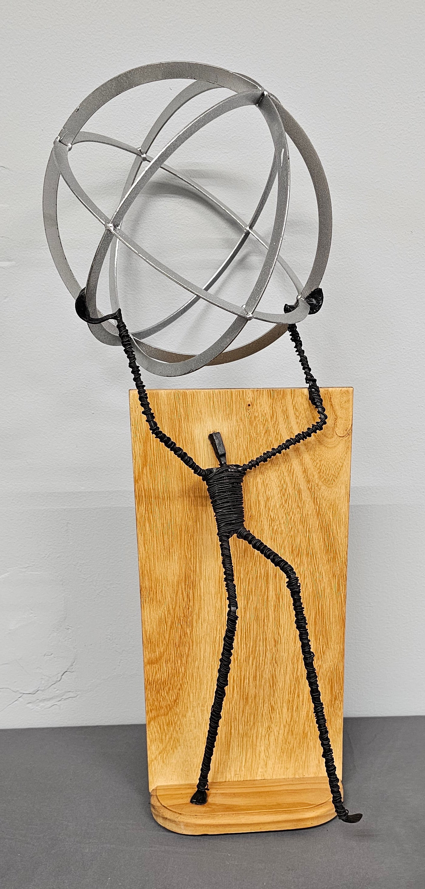 Roger Michels Found Metal & Wood Sculpture: Roger Michels Found Metal & Wood Sculpture. Title- "Weight of the World" Artist signed on base. Collector grade condition. Roger Michels won the award for this piece. He is a member of the Tannery Row