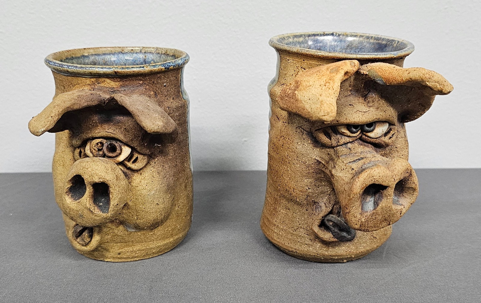 Folk Pottery Pig Coffee Mug Lot: Folk Pottery Pig Coffee Mugs Folk Pottery Pig Coffee Mugs, both are in mint condition. Standing 4 3/4" Tall