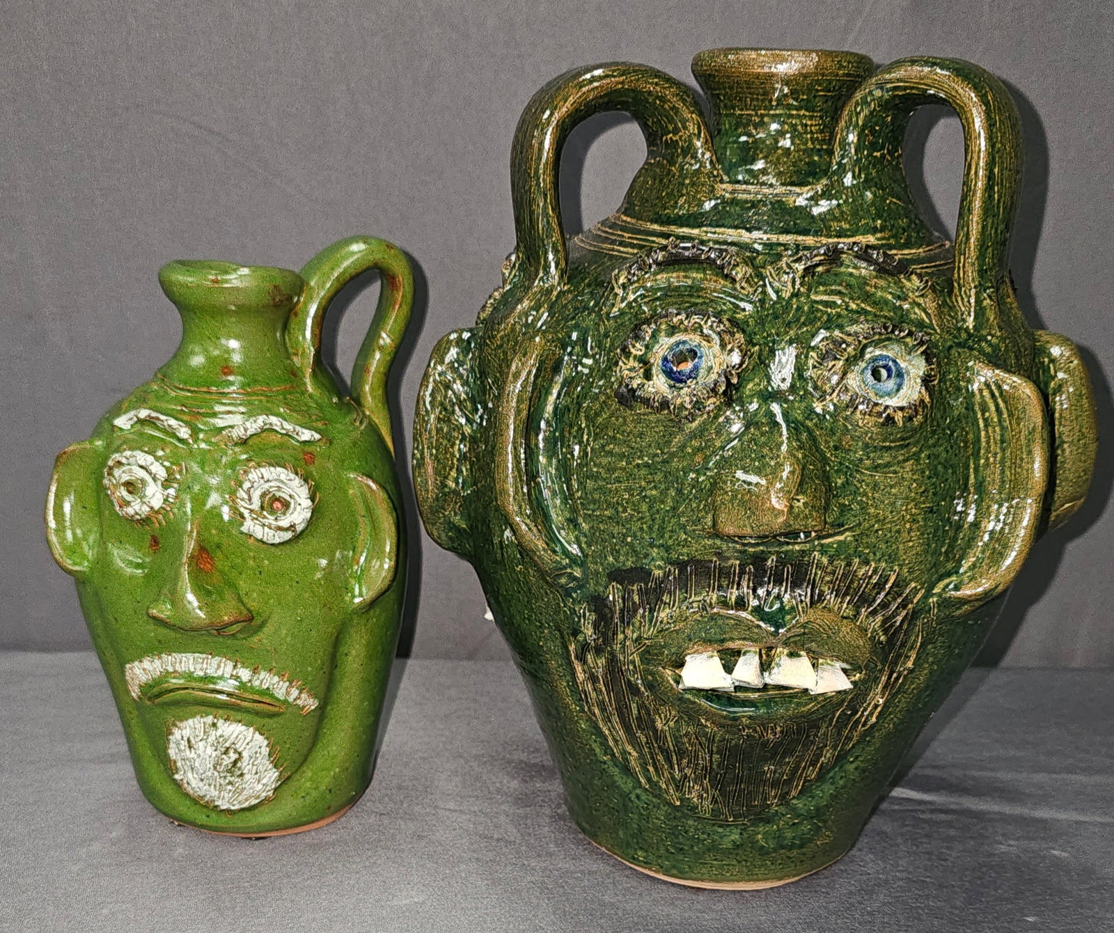 Triple Face Bobby Ferguson Face Jug Lot with Bobby Ferguson & Mary Ferguson Quart Green Face Jug: Triple Face Bobby Ferguson Face Jug Lot with Bobby Ferguson & Mary Ferguson Quart Green Face Jug Circa 07-31-2001, mint condition, standing 7 1/8" Tall Triple face Jug with striking green glaze and ch