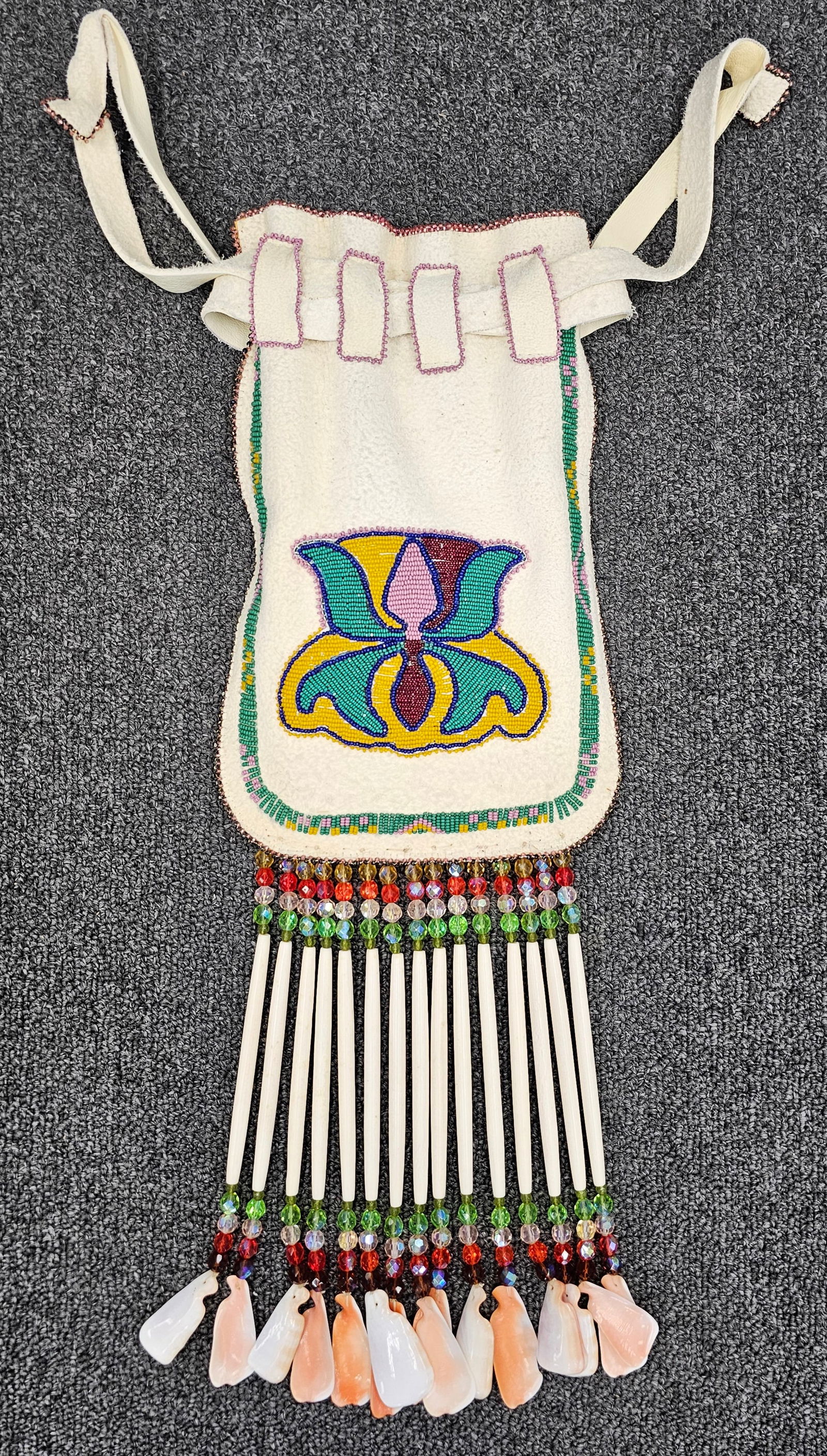 Kiowa Native American Beaded Purse: Native American Beaded Purse By Jo Parker From the Kiowa Tribe. Material- Buffalo Leather, Multi coloed beads, bone and shells. Comes with documentation Size: 18 1/2"
