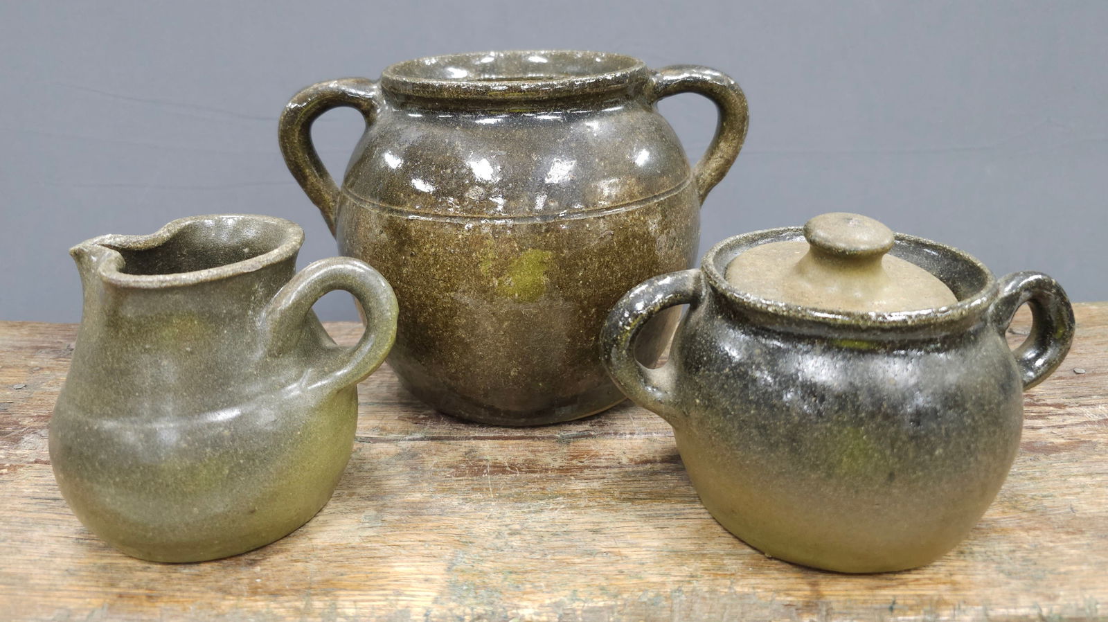 Signed Lanier Meaders Pottery Lot: Signed Lanier Meaders Pottery Lot of three pieces: As Follows Early 1980s Double Handled Pot - No damage. Standing: 5 1/2" Tall Rare Twist Handle Creamer & Sugar, Lid has a firing glaze flake. No dama