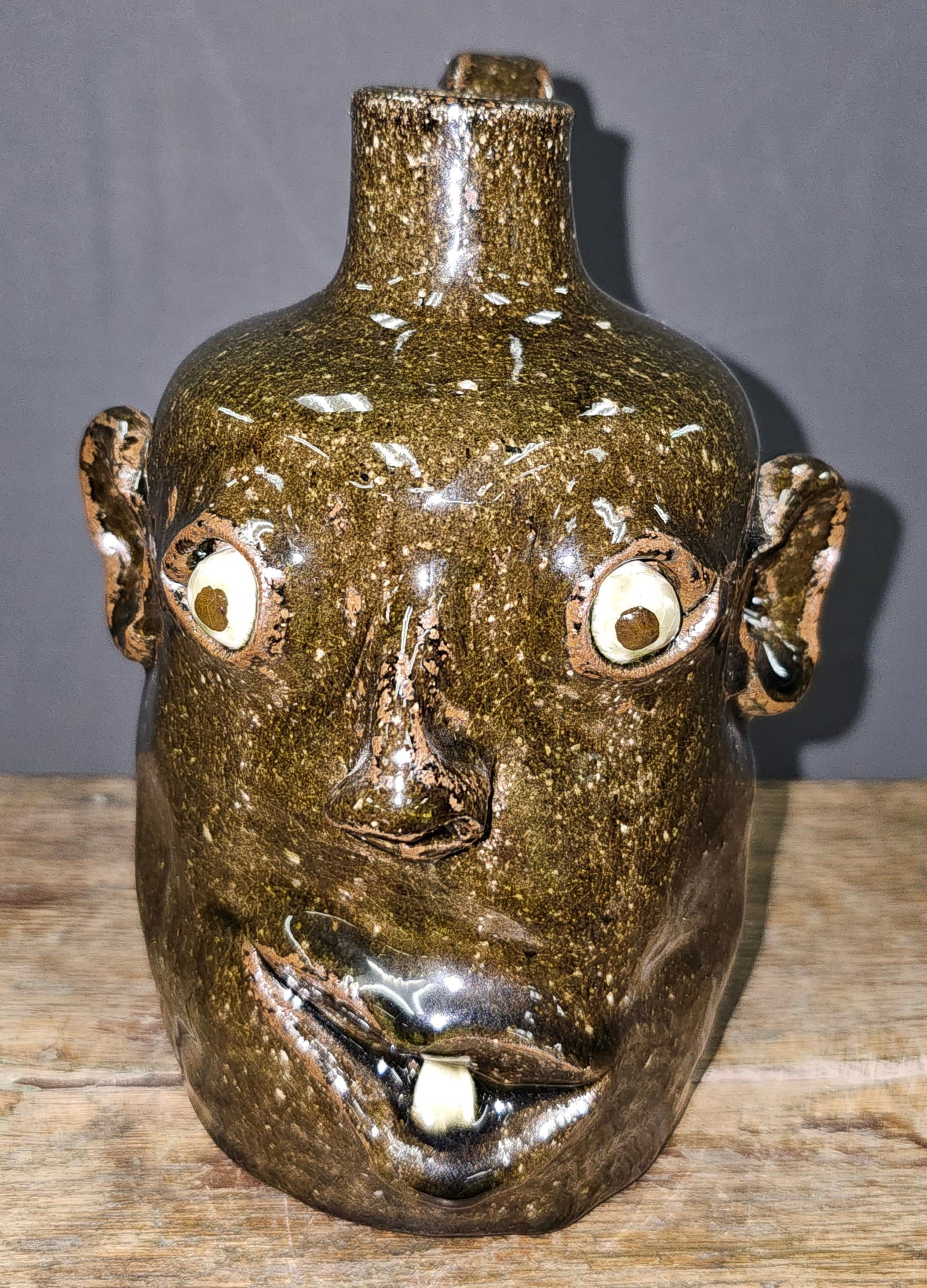 Great David Meaders Face Jug: DAVID MEADERS (1951-2020) Folk Pottery Face Jug Face Jug (7” height). Script signed “David Meaders.” Small size, single ceramic tooth. Undated.