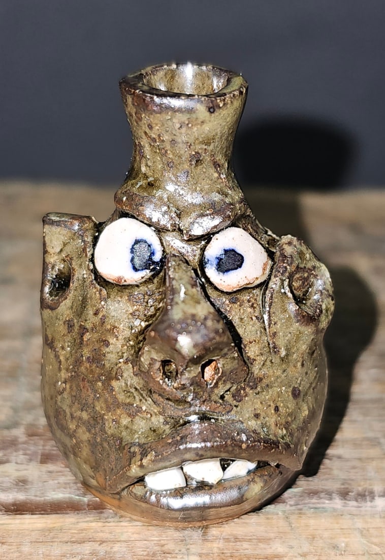 Early Wayne Hewell Mini Face Jug: Early Wayne Hewell Southern Folk Pottery Mini Face Jug, No damage. Outstanding presence in this mini face jug Has china plate teeth. Standing: 2 1/4" Tall
