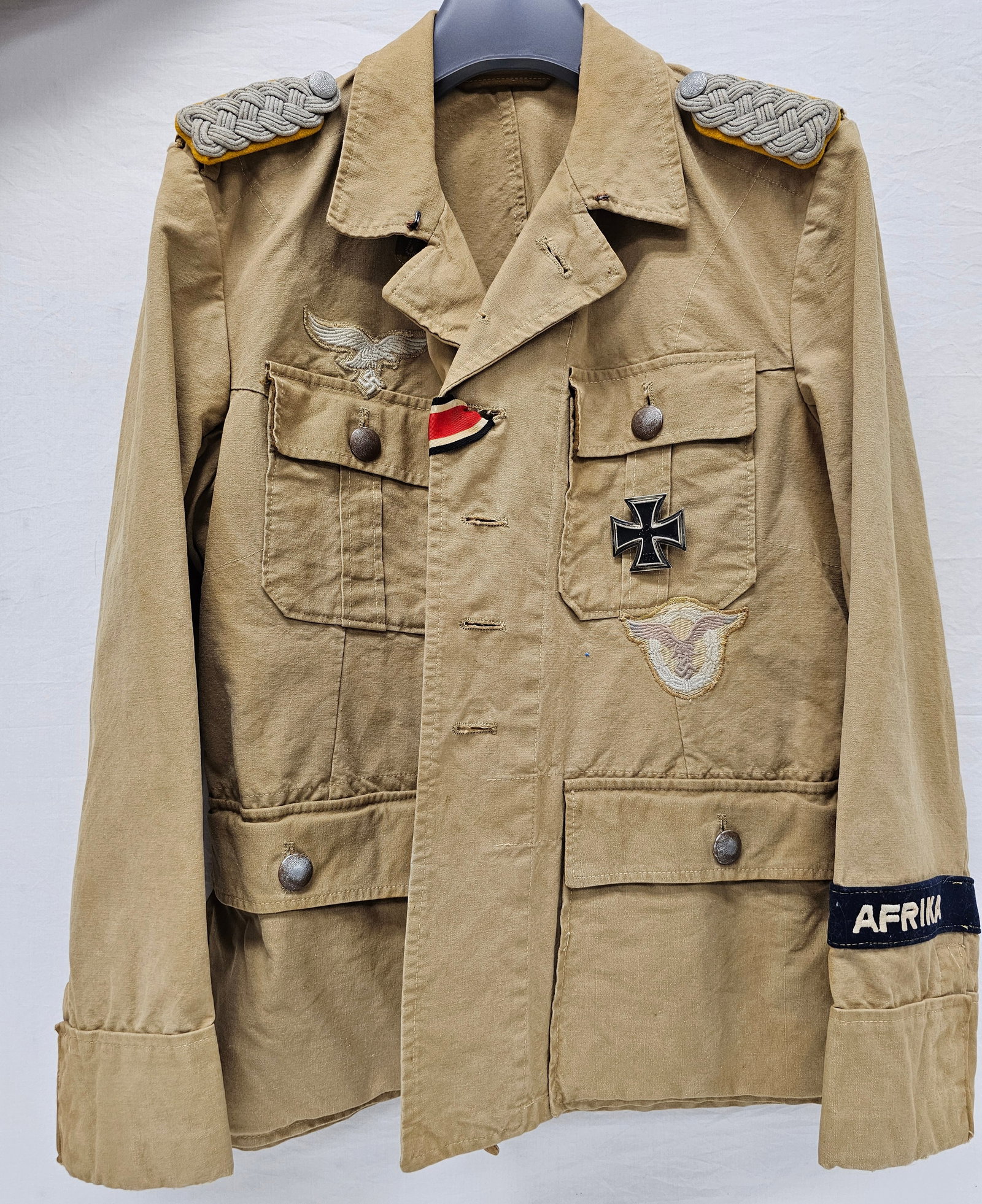 WWII German Afrika Korps Tunic: Authentic WWII German, Afrika Korps Tunic with proper marking on the inside of the tunic. The Tunic is in collector grade authentic original condition, no moth damage. Authentic original patchers and 