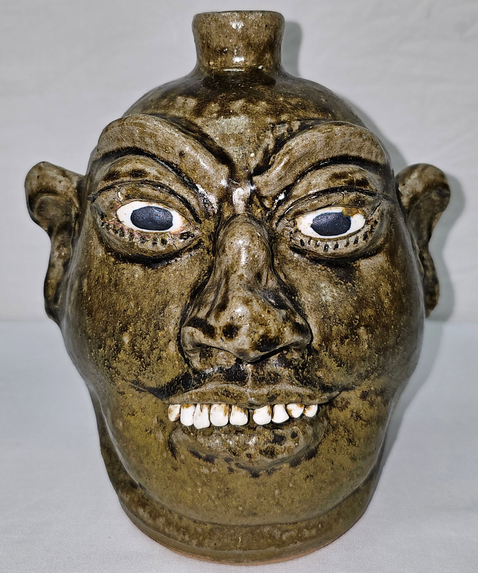 Fine Lanier Meaders Face Jug: Fine Signed Lanier Meaders Face Jug with a row of clay top teeth only and a outstanding glaze with strong facial features. Collector Grade - Mint condition, No damage and No repairs. Standing: 8 1/2"