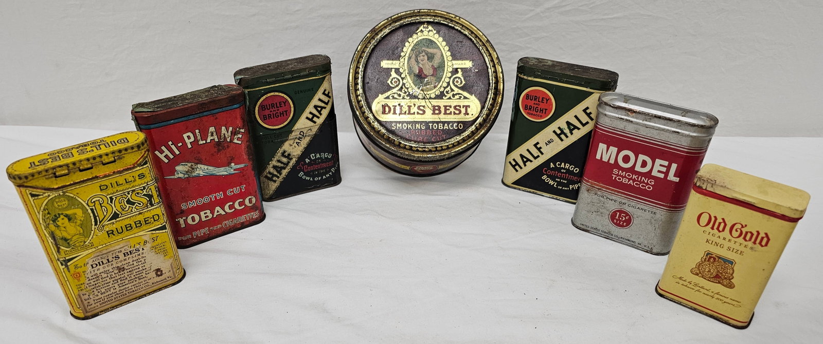 Tobacco Tin Advertising Lot of 7: Tobacco Tin Advertising Lot of Seven, in as seen condition. Half & Half x 2, Model Smoking Tobacco, Old Gold, Dills Best x 2, 1x High Plane Tobacco Tin.