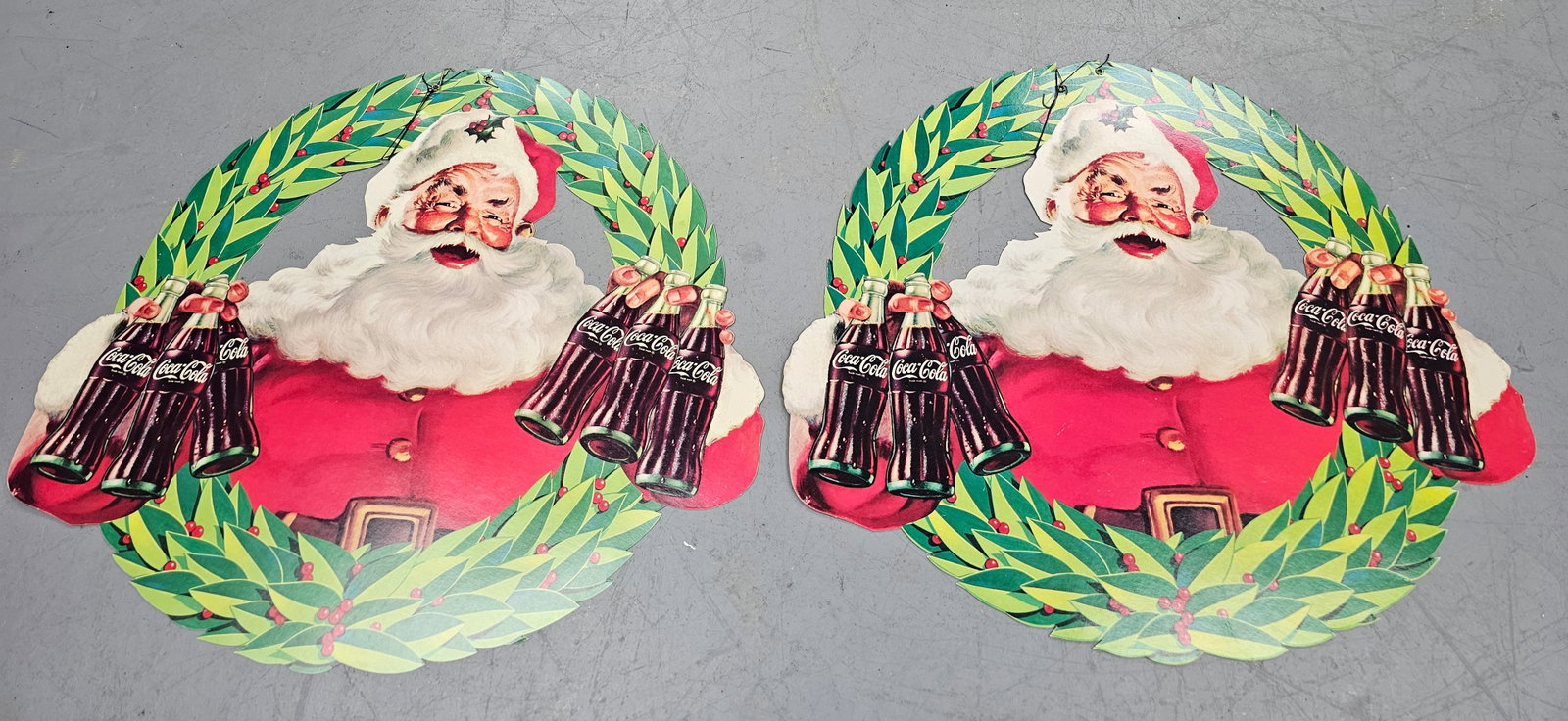 1950s Coca Cola Hanging Santa Christmas Wreath: Rare pair of New Old Stock 1950s Coca Cola Hanging Santa Christmas Wreath, made of cardstock. All original and in collector grade condition. Size: 20 1/2" W x 18" T