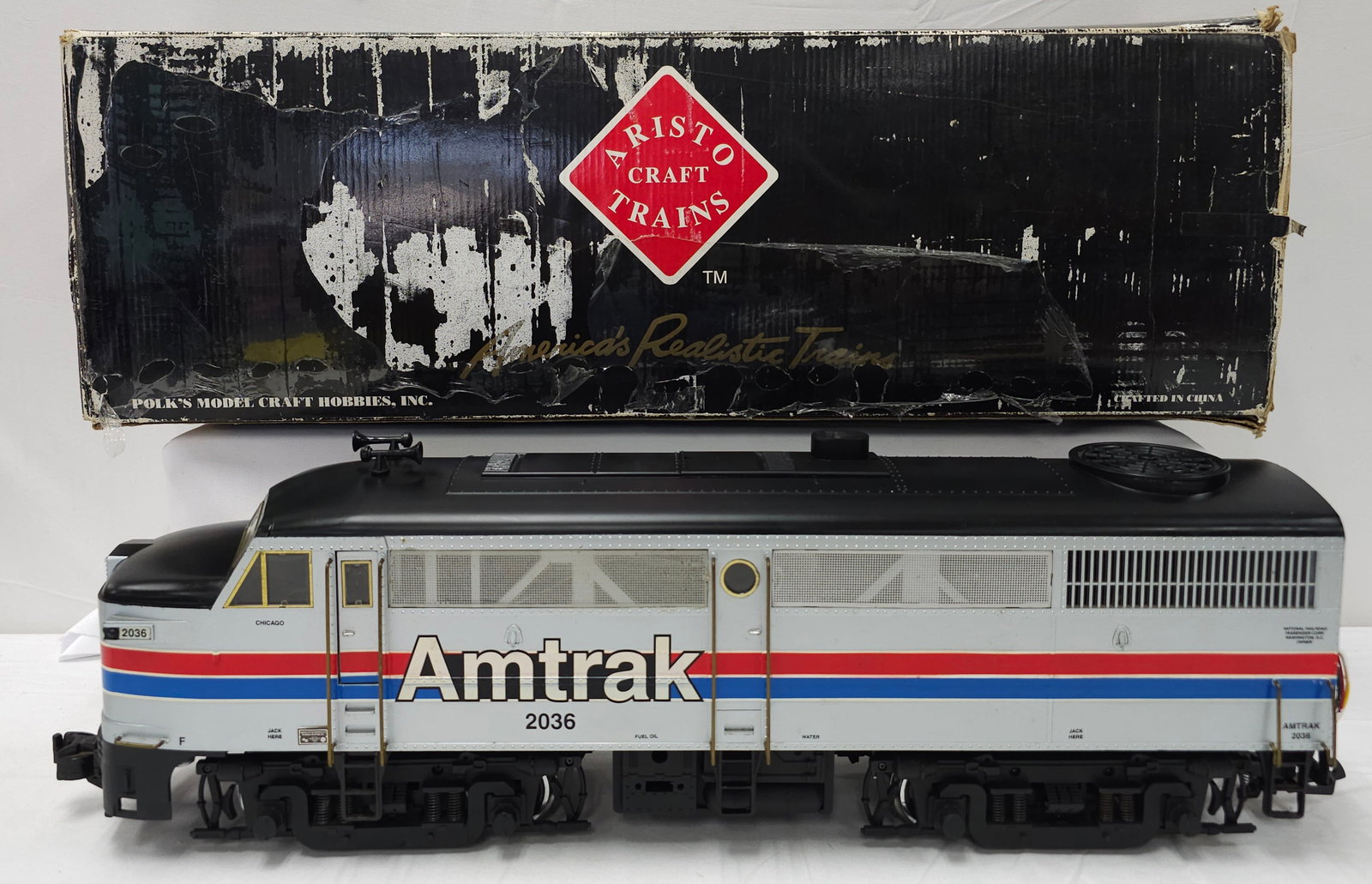 Aristo Craft FA-1 Diesel Amtrak Locomotive: Aristo Craft ART-22336, FA-1 Diesel Amtrak Locomotive, C-7+, With original box. Lights come on, the engine has been converted to a 4 prong battery pack. Strictly a battery powered unit. At this time w