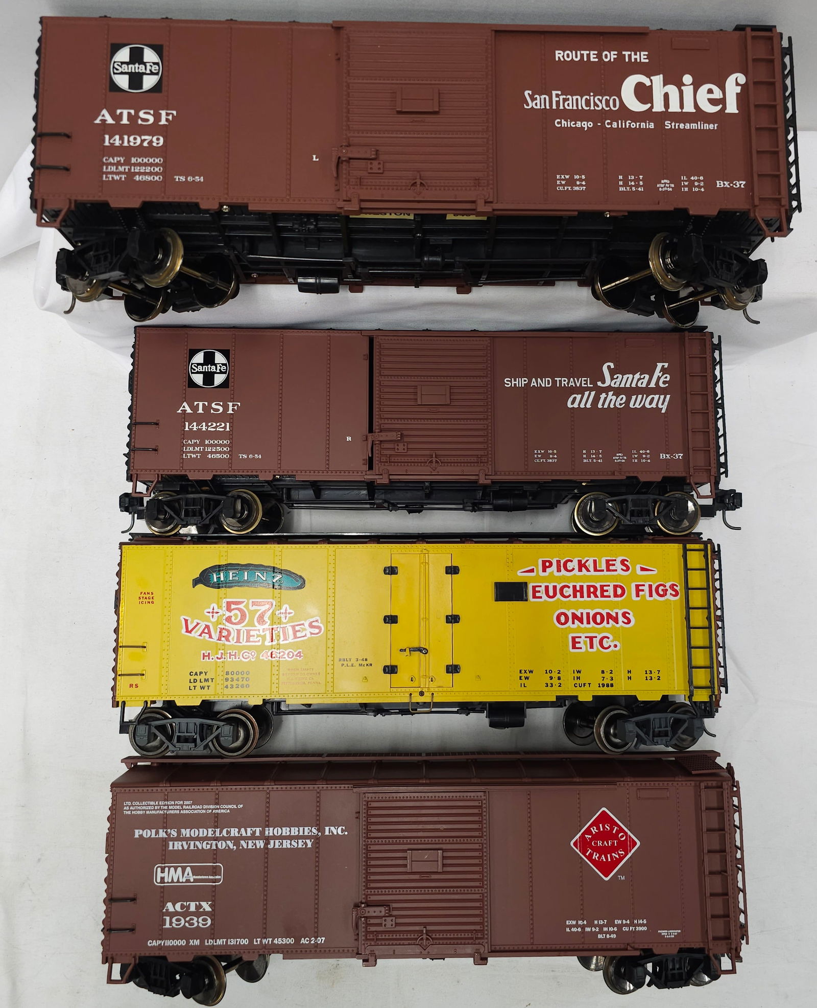 Aristo-Craft G-Scale Boxcar Lot of 4: Aristo-Craft G-Scale Boxcar Lot of 4, C-8. 1. (x2) AT&SF Boxcars #144221 & #141979. 2. J.W. Heinz Pickle Boxcar #46204. 3. Hobby Boxcar.