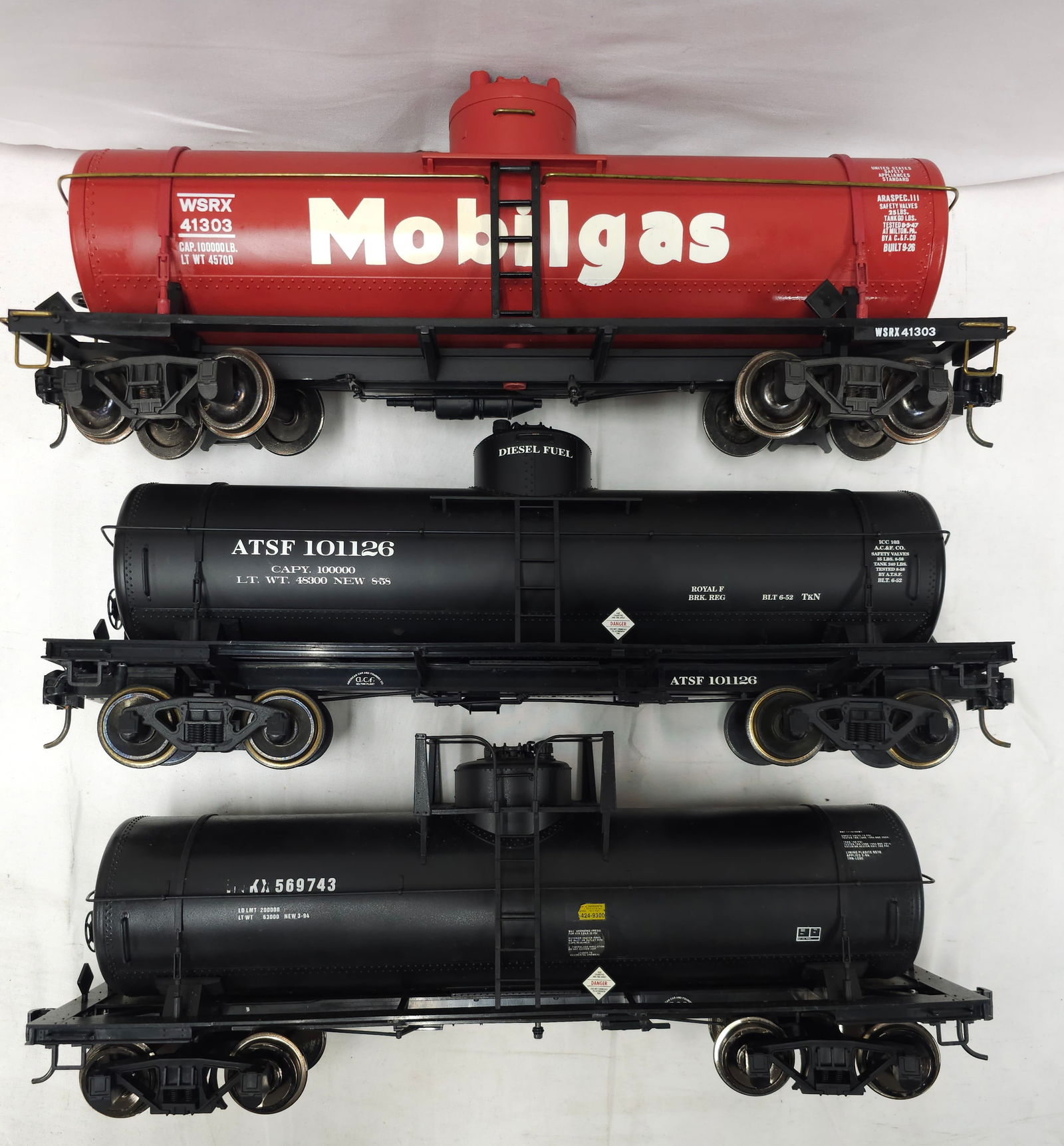 Aristo-Craft & USA TRAINS G-Scale Tank Car Lot 3: Aristo-Craft & USA TRAINS G-Scale Tank Car Lot of 3. 1- Aristo-Craft #41303 Mobile Gas Tank Car, C-8. 2- USA TRAINS (ATSF) Atchison, Topeka and Santa Fe diesel Tank Car, C-7. 3- (HOKX) Hooker Electroc