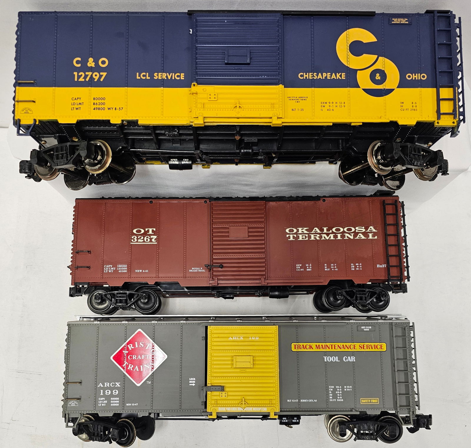 Aristocraft G-Scale Box Car Lot of 3: Aristocraft G-Scale Box Car Lot of Three. 1- Aristo-Craft #199 Track Maintenance Tool Car, C-7. 2- Aristo-Craft #3267 Custom Okaloosa Terminal Box Car, C-7. (Has 2 broken Steps in the ladder.) 3-
