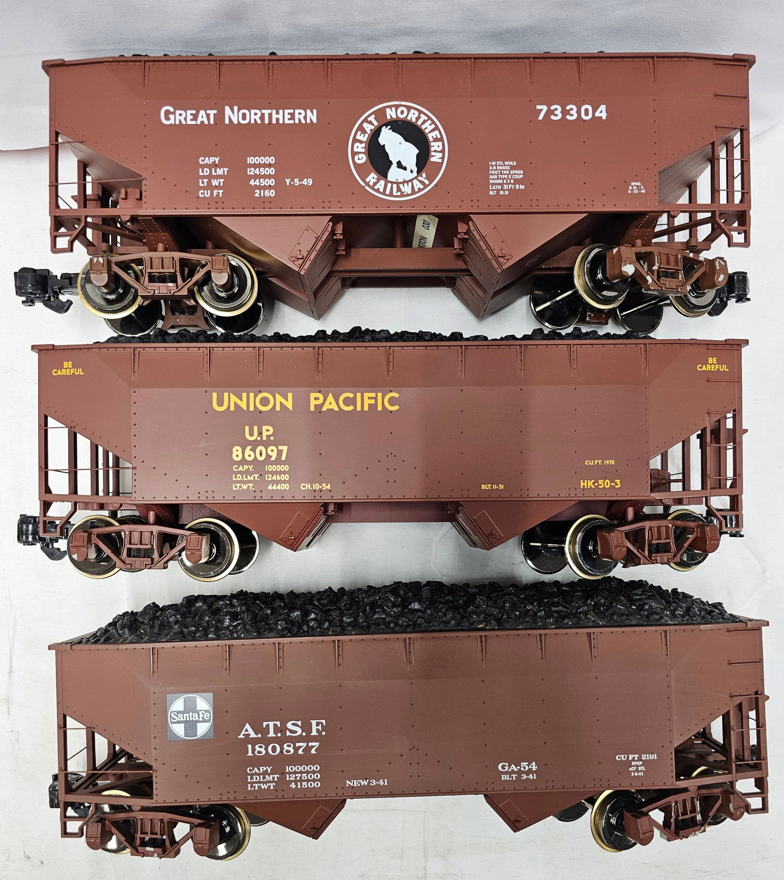 Aristo-Craft G-Scale 2-Bay Coal Hopper W/ Coal: Aristo-Craft G-Scale 2-Bay Coal Hopper W/ Coal Load. All three cars are in C-6+ with paint flaking around the trucks. Otherwise in VG+ condition. 1. Great Norther 73304. 2. Union Pacific 86097. 3.